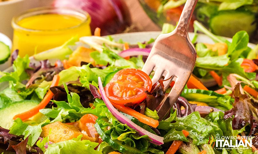 closeup of mixed green salad on a fork
