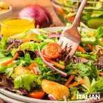 closeup of mixed green salad on a fork