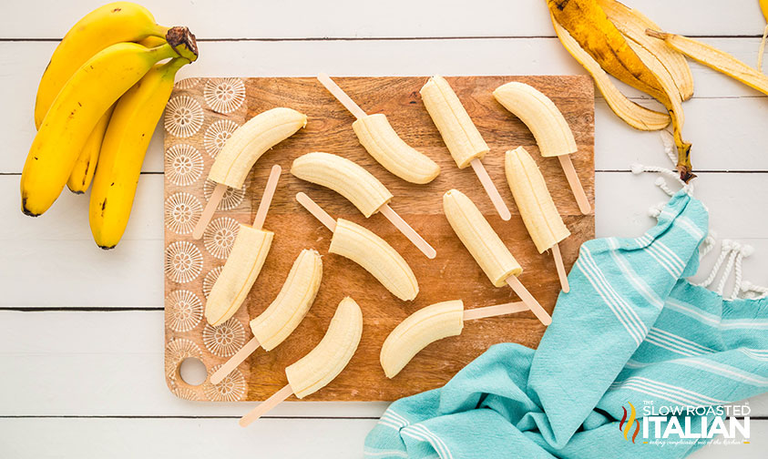 cut banana on popsicle sticks for making chocolate covered bananas
