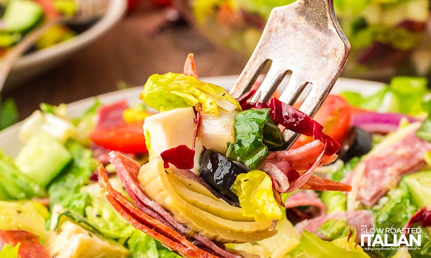 closeup of italian chopped salad on a fork