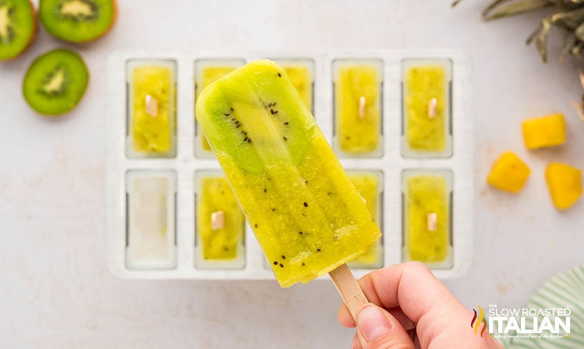 hand holding kiwi popsicles