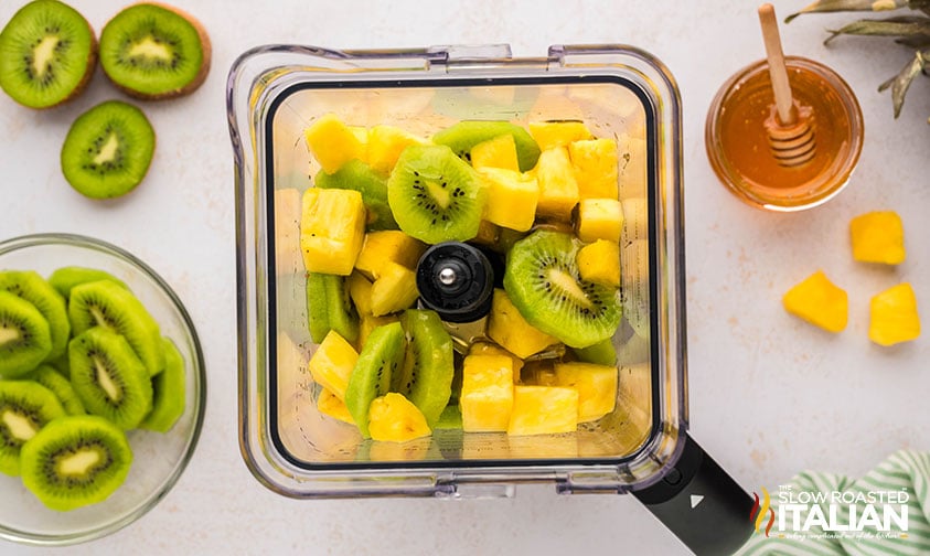 kiwi and pineapple chunks in a blender to make kiwi popsicles