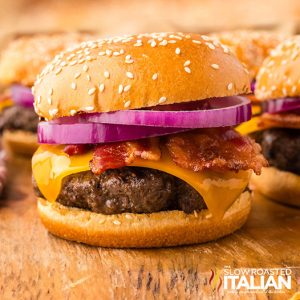 closeup of bbq bacon burger on a wooden board