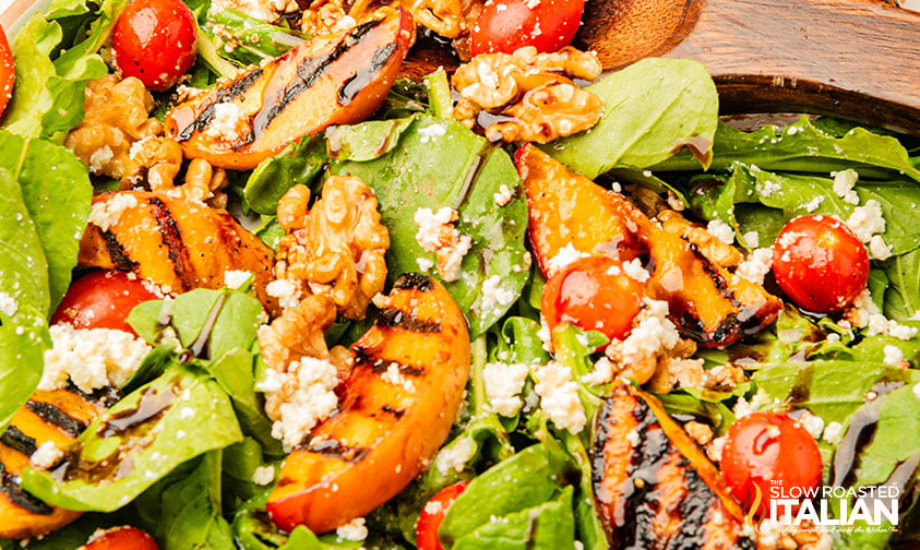 grilled peach salad with arugula, creamy cheese, and toasted nuts