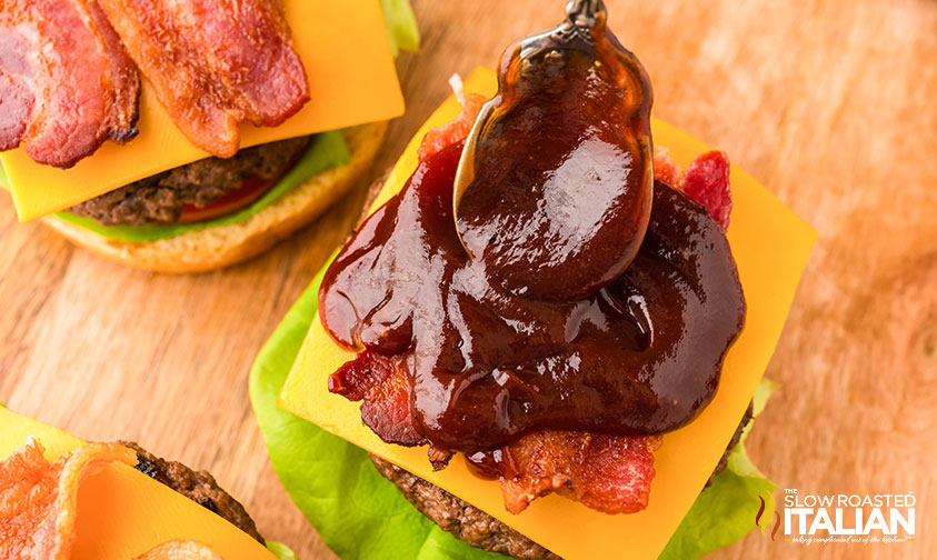 smothering rodeo cowboy burgers in barbecue sauce