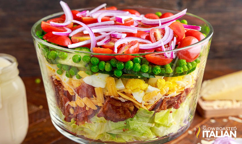 seven layer salad with lettuce, vegetables, bacon, and creamy dressing