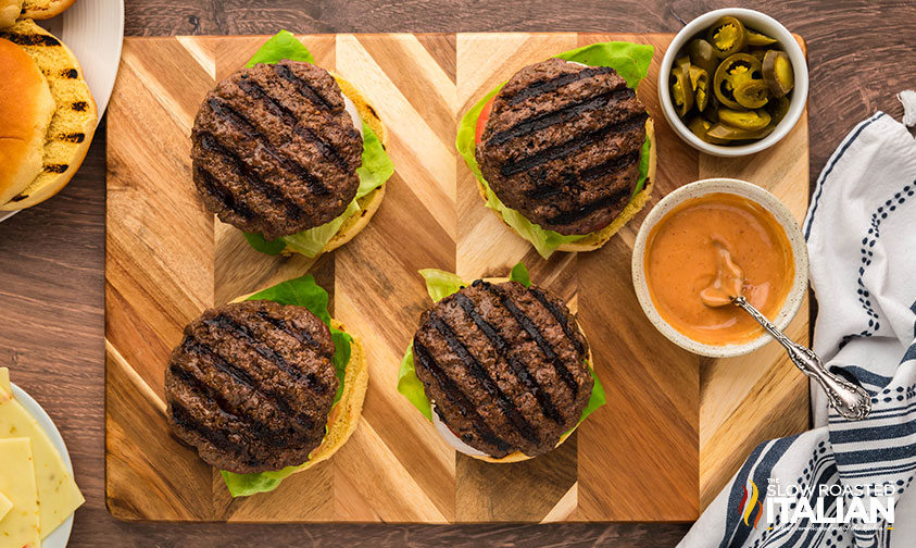 grilled pepper jack burger on buns with sliced jalapenos and sauce