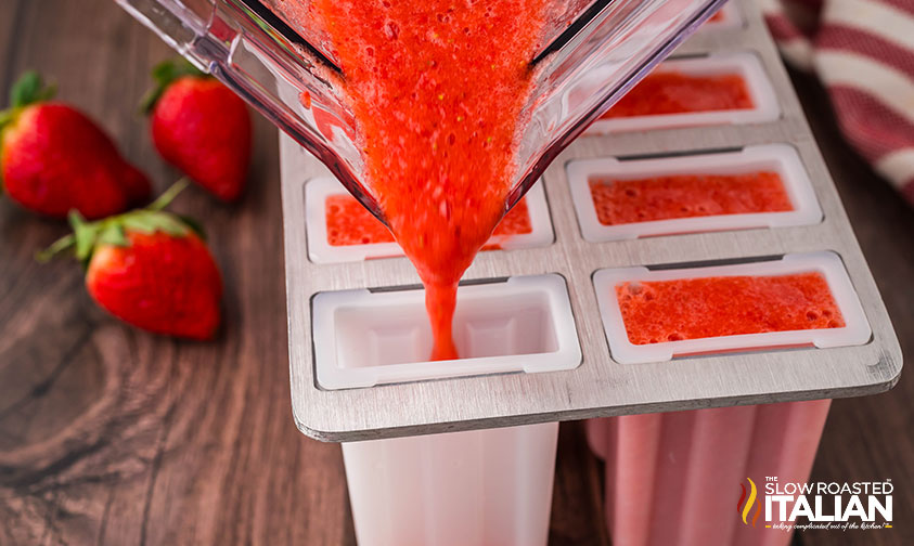 pouring Strawberry Popsicles mixture into popsicle molds