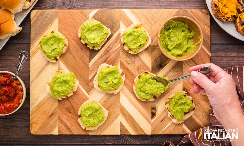 adding guacamole to buns for turkey burger sliders