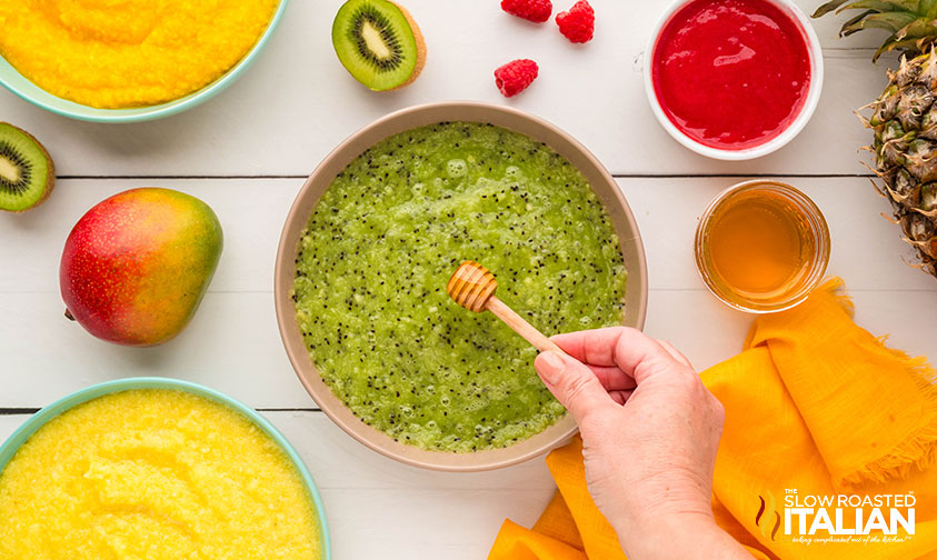 adding honey to pureed kiwi for making tropical popsicles