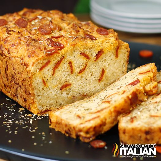 closeup of sliced cheesy pepperoni pizza beer bread