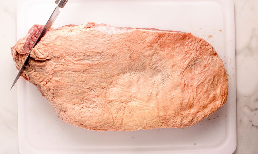 trimming the edge of a brisket