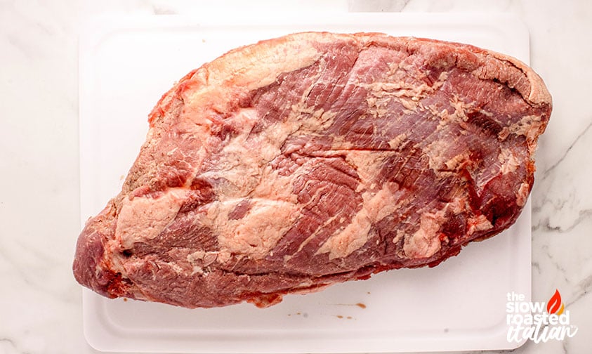 whole brisket on a cutting board