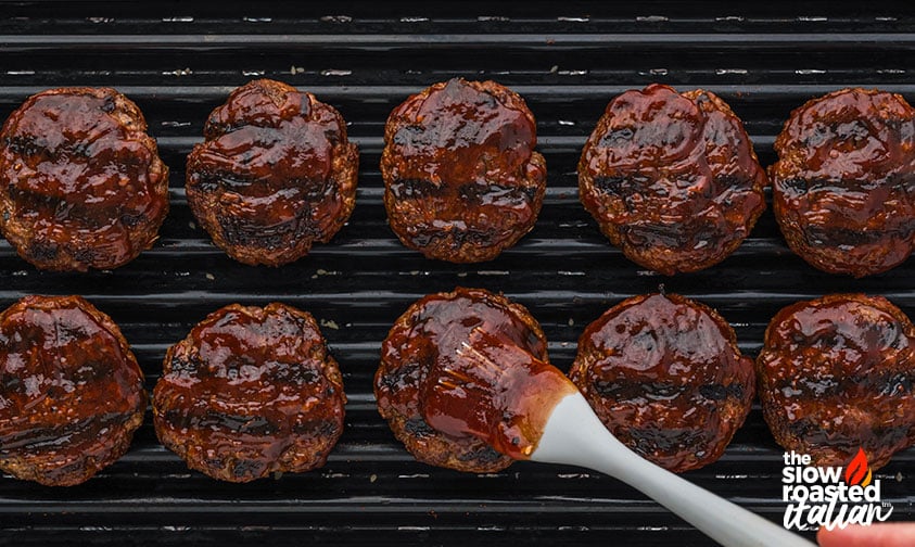 adding sauce to grilled bbq sliders