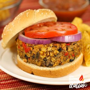 closeup of homemade veggie burgers with slices of red onions and tomato