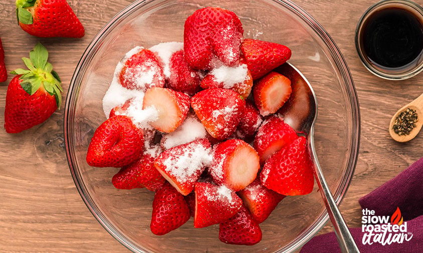 fresh strawberries in a bowl with sugar for making strawberry ice pops