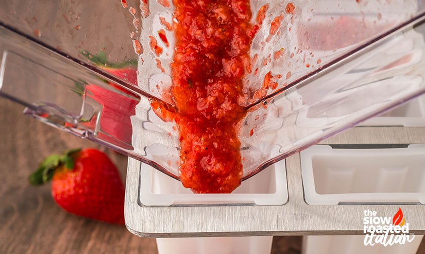 filling ice pop mold with strawberry balsamic mixture