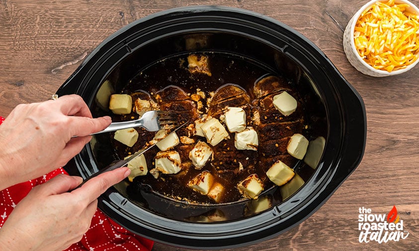 Mexican shredded chicken crockpot strands pulled apart with a fork