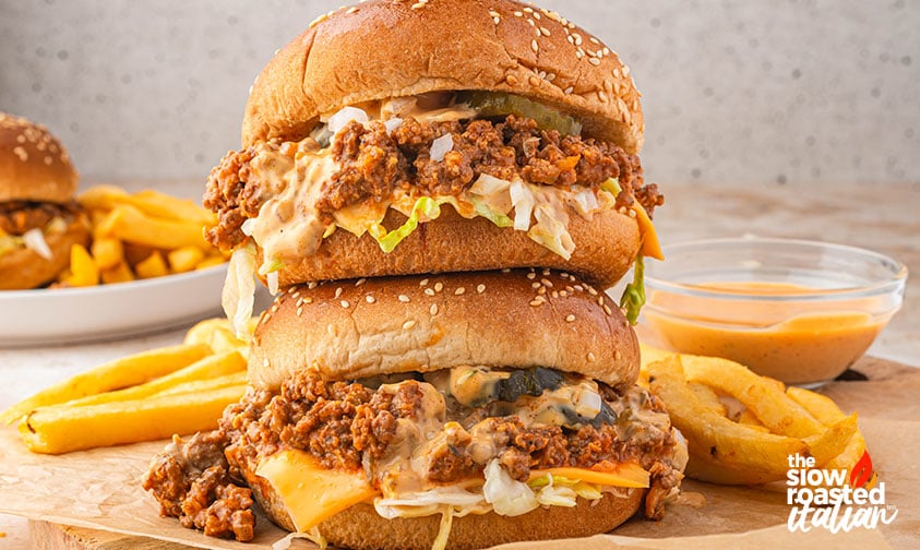 Stacked Big Mac sloppy joes on sesame buns served with fries and a bowl of special sauce