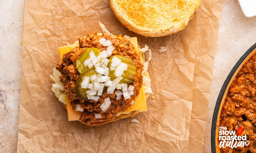 Big Mac sloppy joe topped with diced onion and pickles before adding the top bun