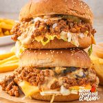 Close-up of stacked Big Mac sloppy joes on sesame buns with cheese, pickles, shredded lettuce, and special sauce