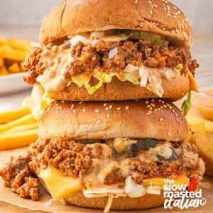 Close-up of stacked Big Mac sloppy joes on sesame buns with cheese, pickles, shredded lettuce, and special sauce
