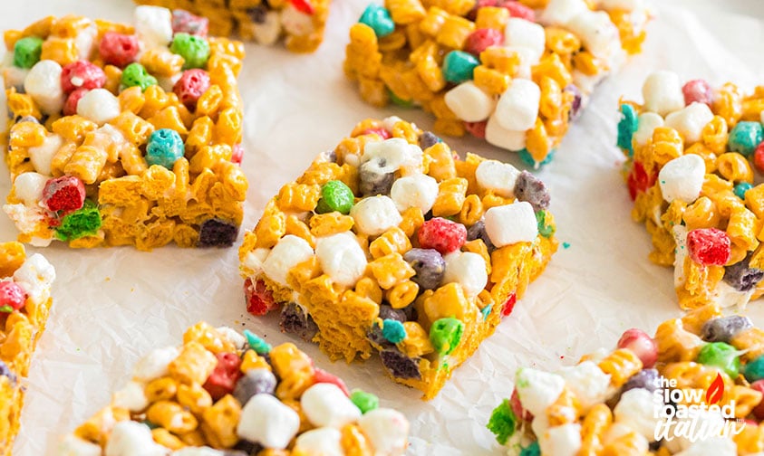 Overhead view of Cap’n Crunch cereal bars cut into squares and arranged on parchment paper
