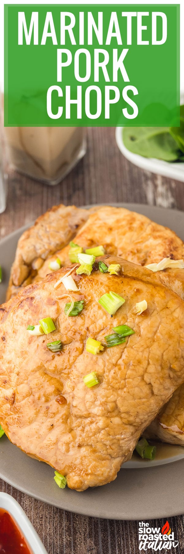 Marinated pork chops seared golden brown and topped with green onions, served on a plate