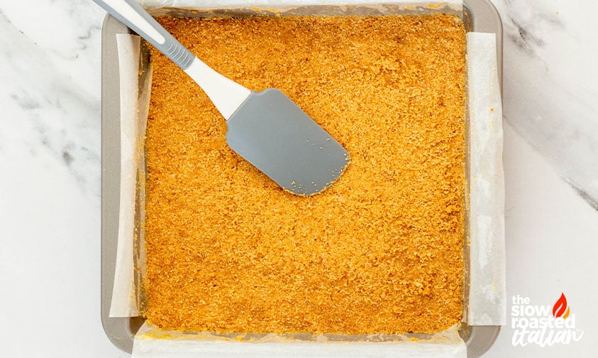 Graham cracker crust pressed into a parchment-lined 9x9 baking dish