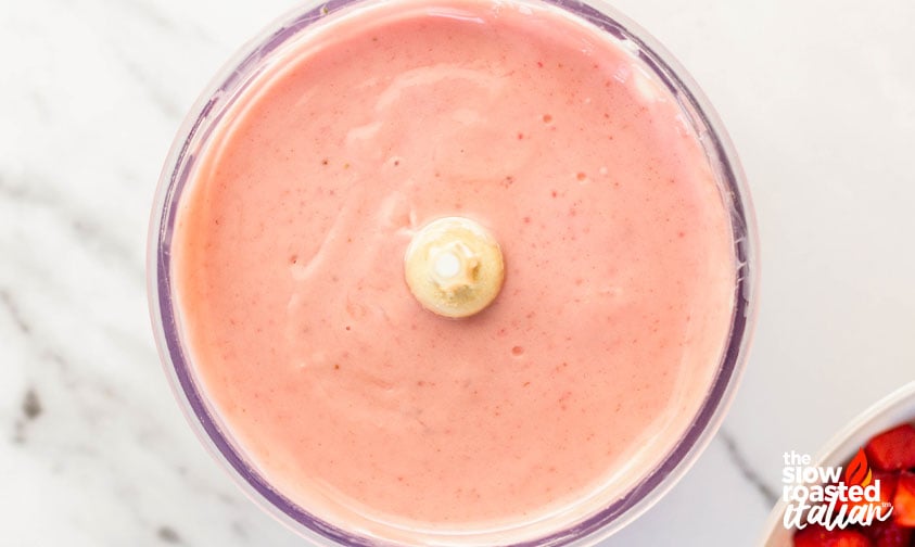 Pink strawberry cream cheese filling in a food processor