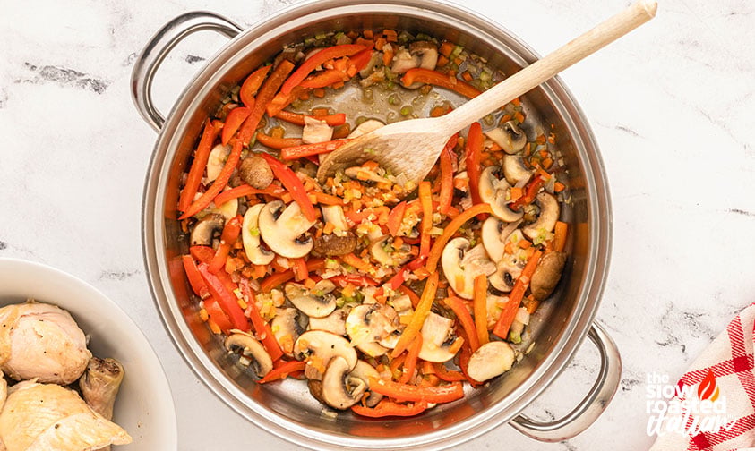 Process, vegetables: mushrooms, red bell pepper, onion, carrot and celery softening in the pot