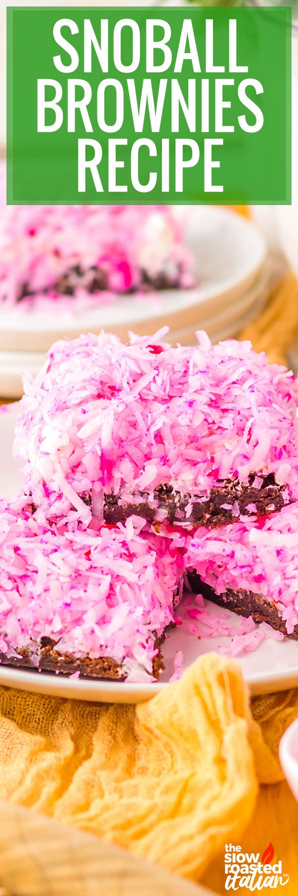 Stacked coconut brownies with pink shredded coconut topping, cut into squares showing the fudgy brownie layer