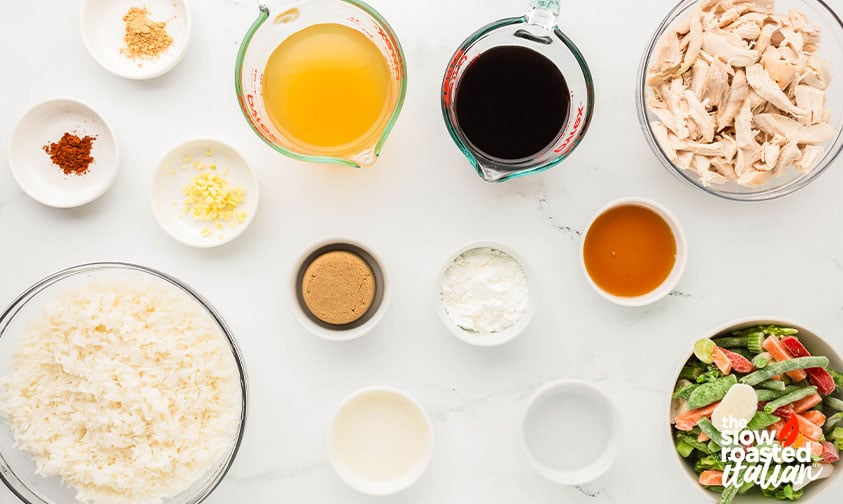 Ingredients for teriyaki chicken casserole including shredded chicken, rice, soy sauce, chicken broth, cornstarch, and frozen stir-fry vegetables