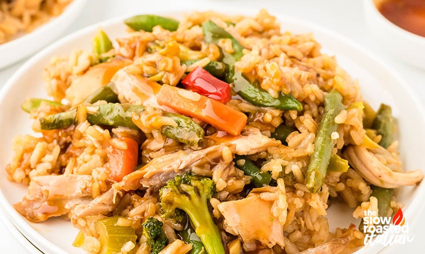 Plated teriyaki chicken casserole with rice, broccoli, carrots, and snap peas